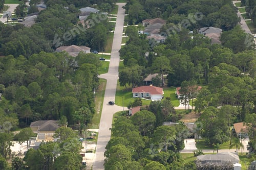 Preview: Aerial landscape view of suburban private houses between green palm trees in Florida