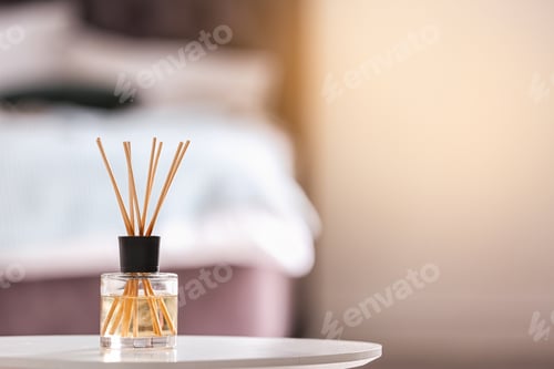 Preview: Aromatic reed air freshener on table against blurred background