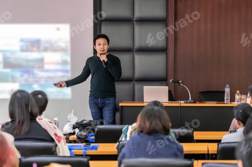 Preview: Asian Speaker or lecture with casual suit on the stage presenting via projector screen