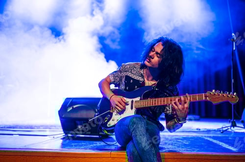 Preview: Rock and roll group performing live.