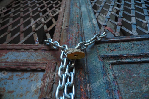 Preview: Closed old rusty lock on a wooden door