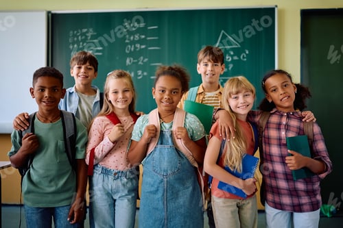 Preview: Multiracial group of happy schoolkids in the classroom looking at camera.