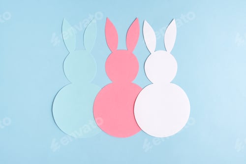 Preview: Easter concept. Three paper rabbits on a blue background. Easter background.