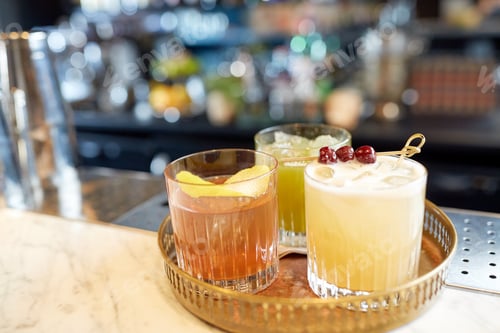 Preview: tray with glasses of cocktails at bar