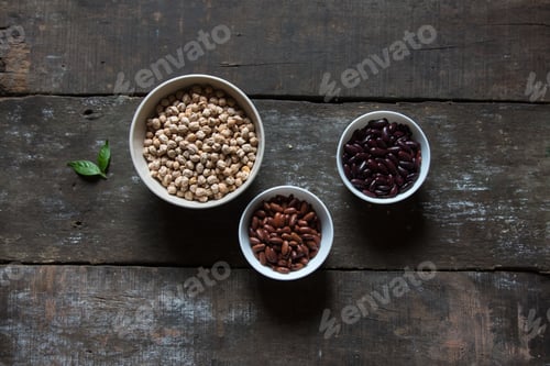 Bowls of Legumes on Rustic Wooden Table