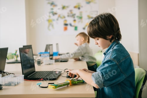 Preview: kid constructing robot at stem education class