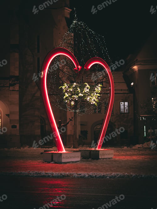Preview: Vertical shot of a red heart sign decorated with lights