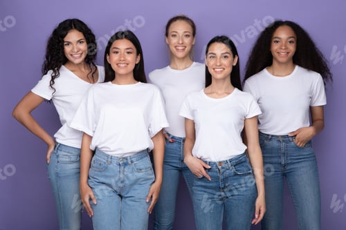 Preview: Pretty Diverse Women Standing Over Purple Studio Background