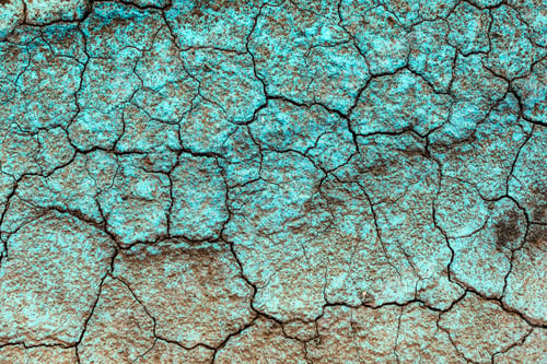 Preview: Blue copper fungicide on dry cracked ground as background