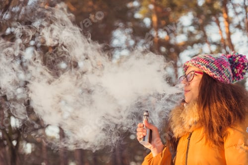 Preview: Electronic Cigarette. The Girl Smokes Electronic Cigarette.