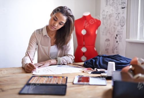 Preview: Creating this seasons trends. A fashion designer creating sketches in her office.