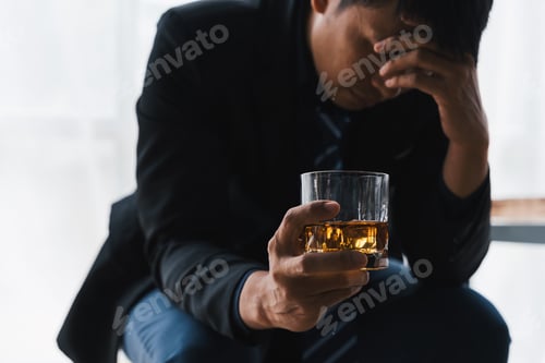Preview: drunk asian man hold whisky glass addicted alcohol need therapy.