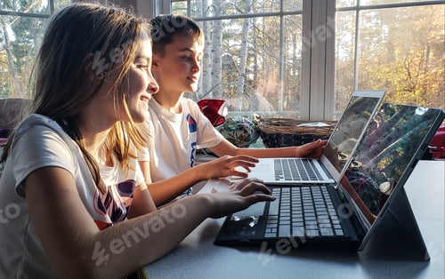 Preview: Generation z kids being kids back to school and working together on their homework in home.