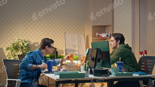 Preview: Hungry startupers taking pizza slices work place. Two men sharing lunch at break