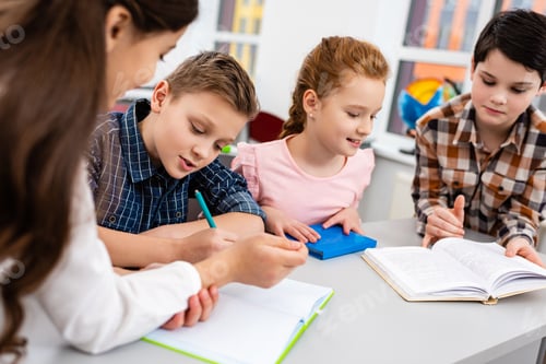 Preview: Four pupils with notebook and books at desk in classroom