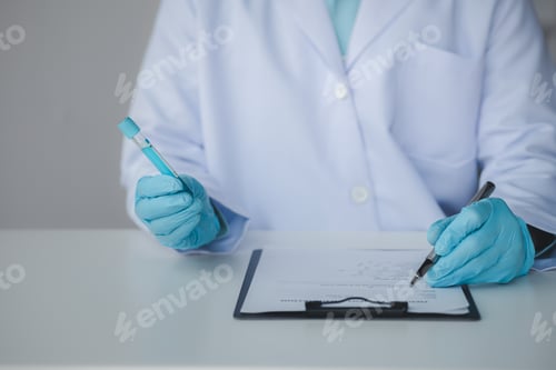 Preview: Lab assistant, a medical scientist, a chemistry researcher holds a glass tube through the blood samp