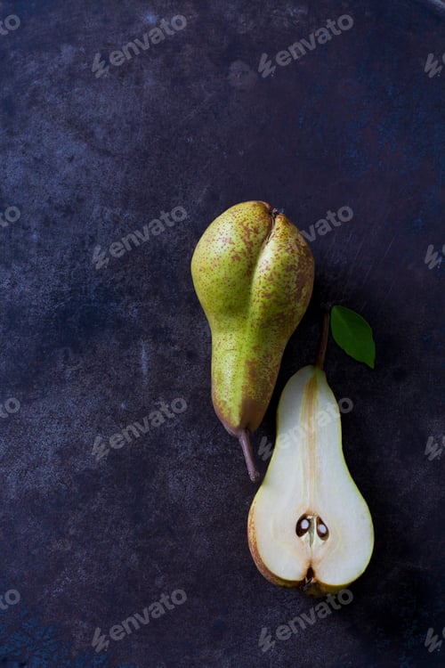 Preview: Sliced and whole pear on dark ground