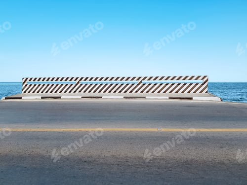 Preview: Bridge with Black and White Striped Paint Against Blue Sea and Sky