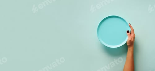 Preview: Female hand holding empty blue plate on pastel background with copy space. Healthy eating, diet