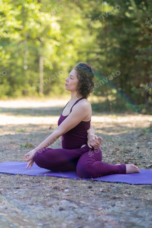 Preview: Young woman doing twists while sitting
