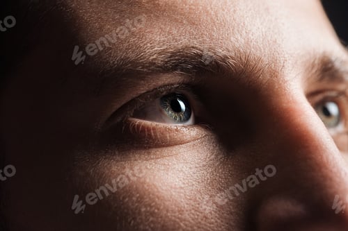 Preview: close up view of adult man looking away in darkness