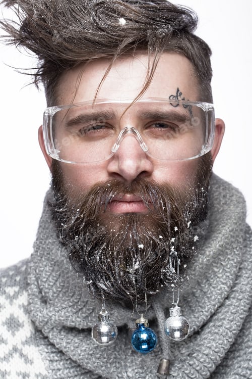 Preview: Funny bearded man in a New Year's image with snow and decorations on his beard. Feast of Christmas.