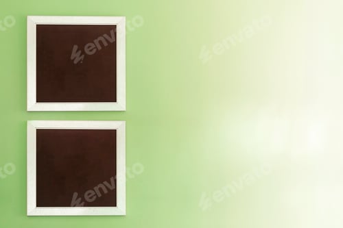 Preview: Empty photo frames on green wall with free space background.