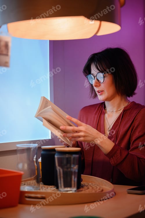 Preview: Woman Reading a Book in Cozy Ambient Lighting