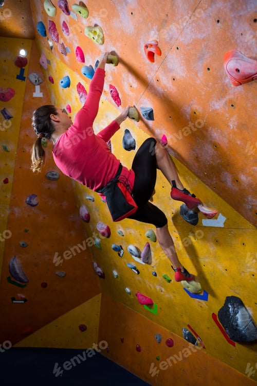 Preview: Determined woman practicing rock climbing