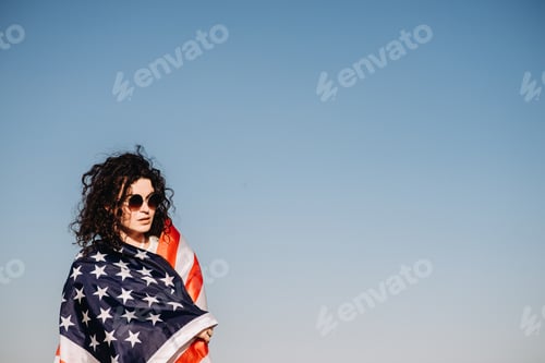 Preview: Girl with an American flag. Independence Day concept