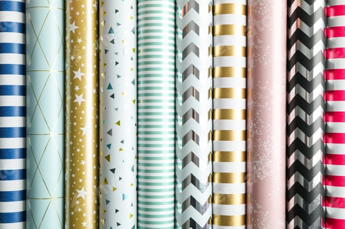 Preview: Rolls of festive wrapping paper as background. Top view