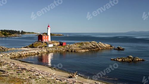 Preview: The Fisgard Lighthouse and it's beautiful reflection in the ocean water on a clear spring day.