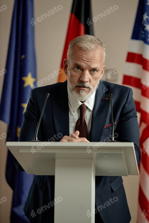 Preview: Portrait of Middle Aged Caucasian Man Giving Speech at Podium during Conference