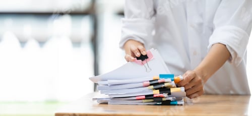 Preview: Businesswoman hands working in Stacks of paper