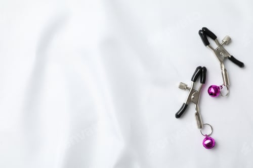 Preview: Erotic nipple clips on a light background.