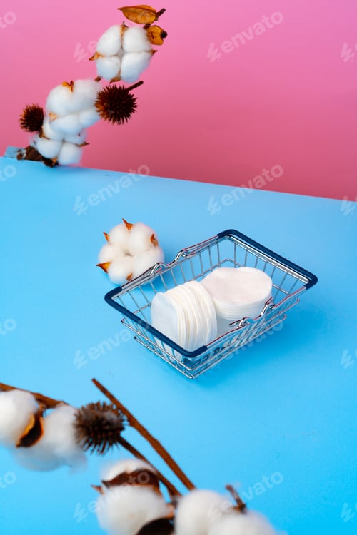 Preview: Cotton discs stack on blue paper background