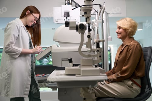 Preview: Young doctor at a reception communicates with a middle-aged lady