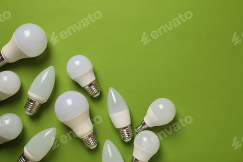 Preview: Energy saving bulbs on green background, space for text