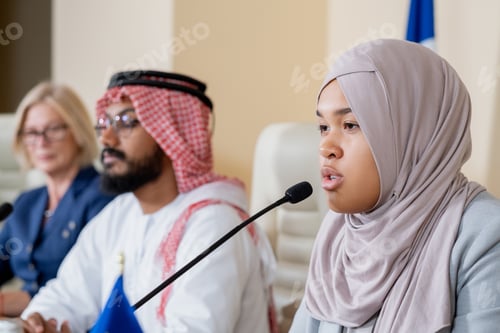 Preview: Young contemporary female delegate in hijab making speech