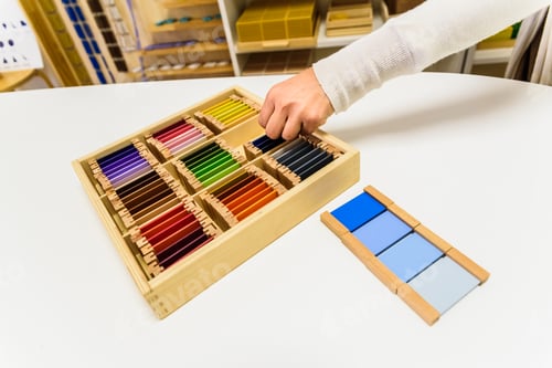 Preview: Montessori student hands using sensory materials in a school.