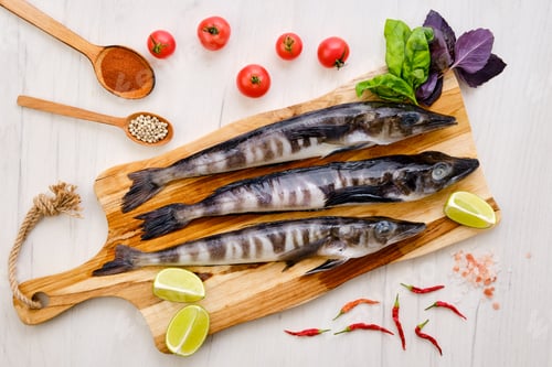 Preview: Top view of fresh icefish on wooden cutting board