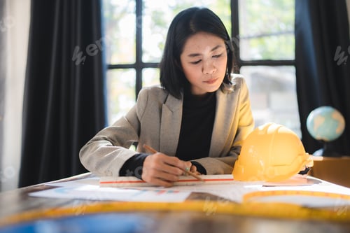 Preview: A woman is writing with a pencil on a piece of paper