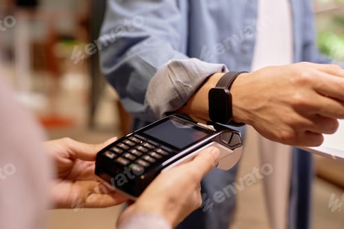 Preview: Man Using Smartwatch for Contactless Payment Transaction