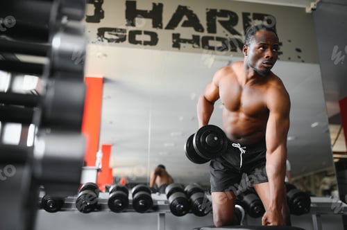 Preview: African American young man doing workout at the gym