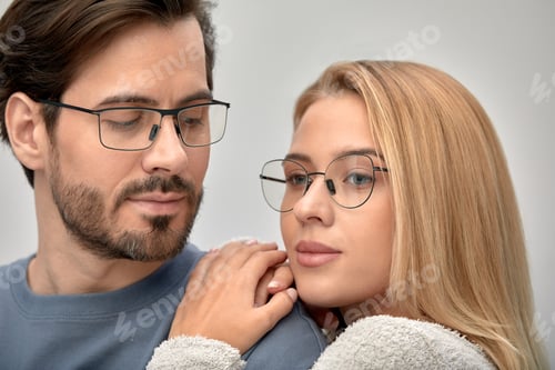 Preview: Close-up of an embracing couple in glasses, a man and a woman 25-35 years old are hugging on camera