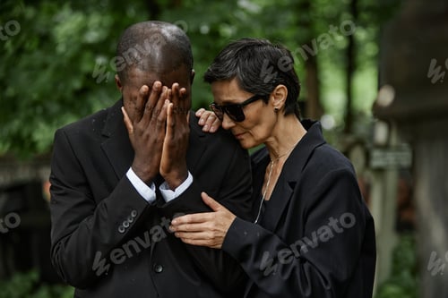 Preview: Senior Woman Comforting Grieving Black Man at Graveyard