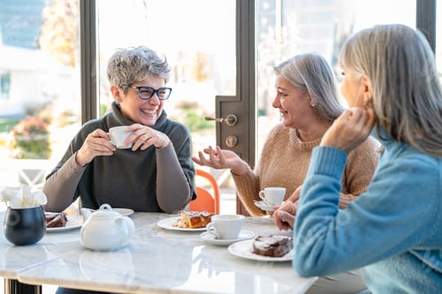 Preview: Group of elderly women having fun during breakfast in a cafeteria