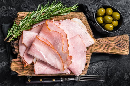 Preview: Pork ham slices on cutting board, Italian Prosciutto cotto. Black background. Top view