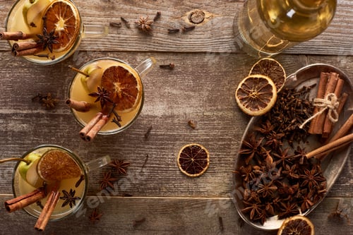 Preview: top view of traditional pear mulled wine with spices on wooden rustic table
