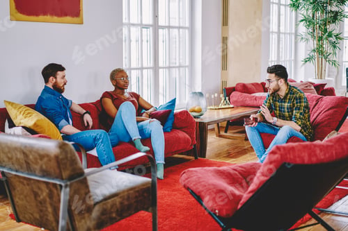 Preview: young hipsters talking indoors spending free time together at home